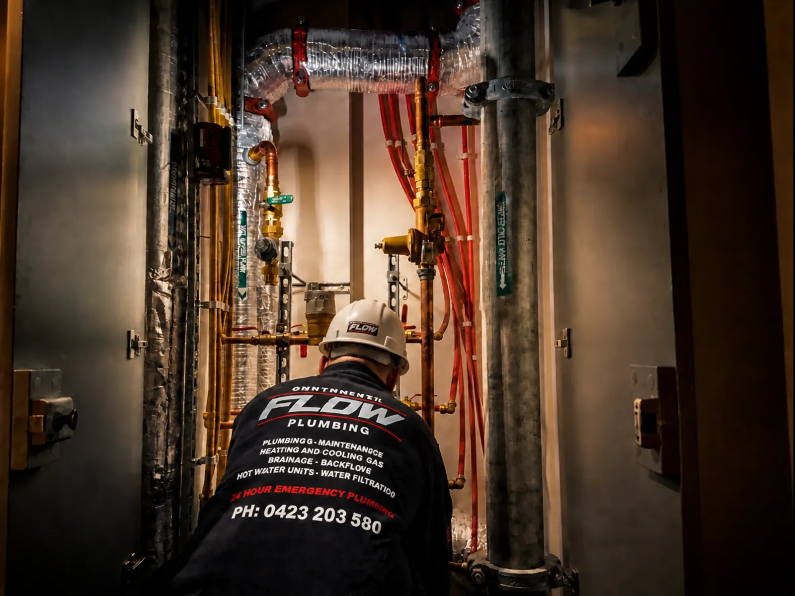 Controlled Flow Plumbing technician inspecting hydraulic pipework in a commercial plant room