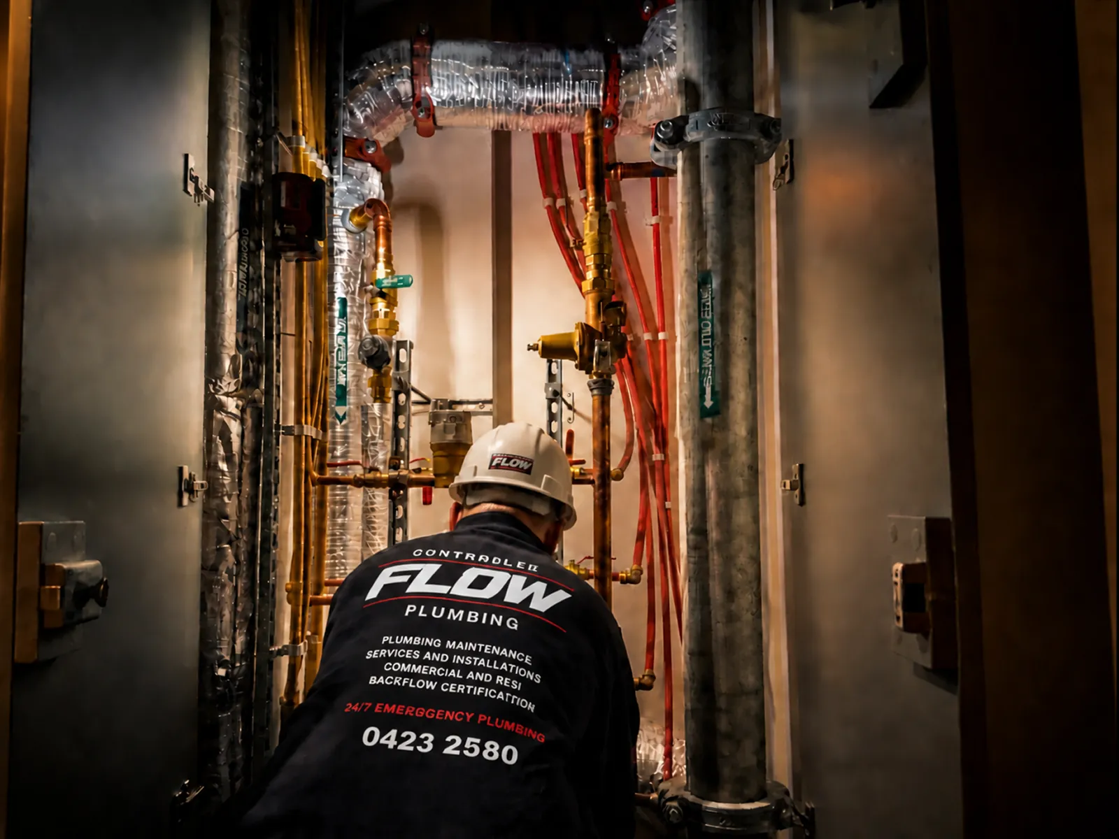 Controlled Flow Plumbing technician inspecting hydraulic and gas pipework in a commercial plant room
